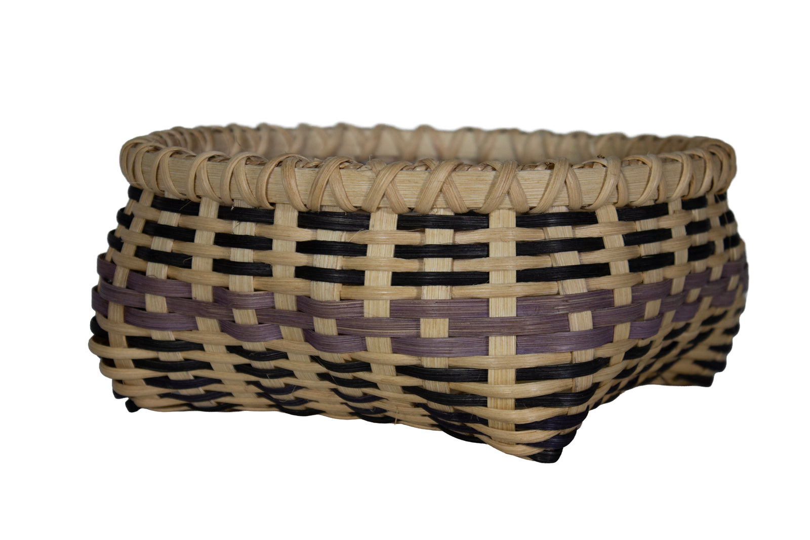 A hand-woven basket with a natural tan base, black woven stripes, and a purple accent stripe, isolated on a white background.